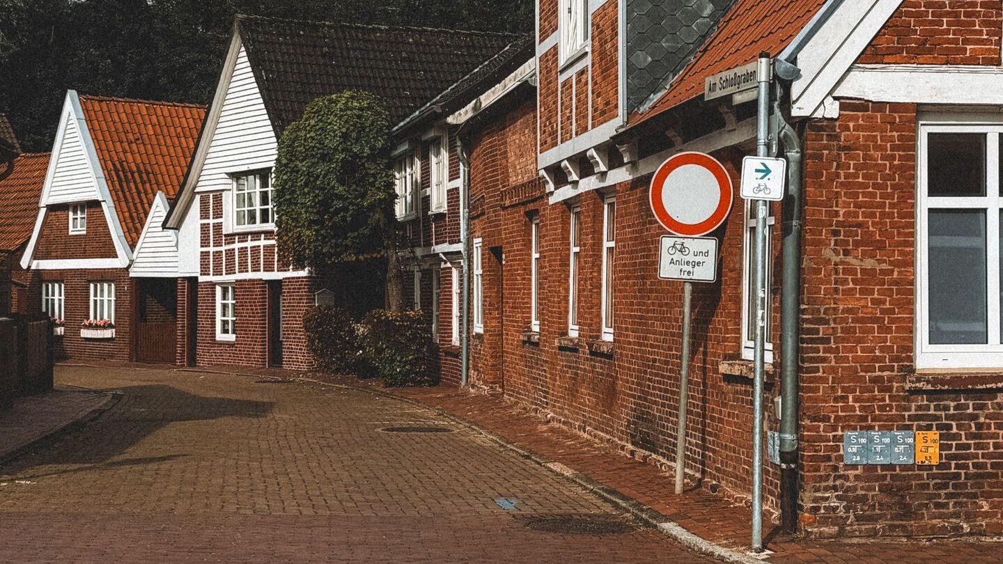 Picturesque red-brick houses in Ottendorf-Okrilla, Germany on a quiet street.